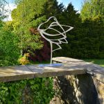 Stainless steel garden sculpture on wall