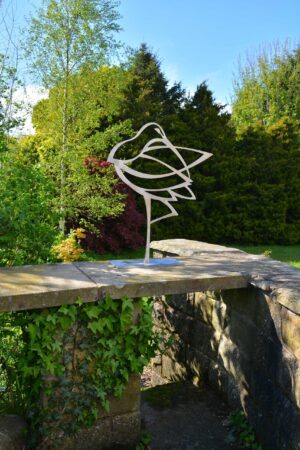 Stainless steel garden sculpture on wall