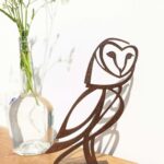 small rusted steel barn owl sculpture