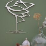 Stainless steel wall mounted curlew with green background